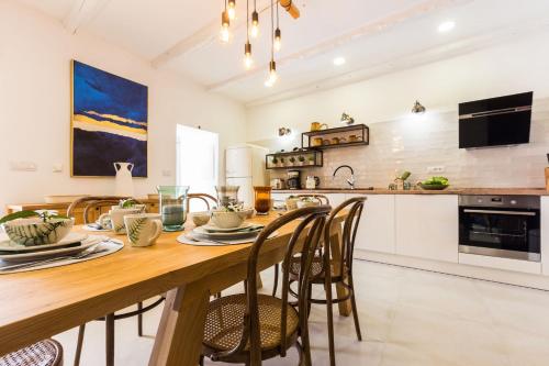 a kitchen with a large wooden table and chairs at Vila Gallo in Galovac