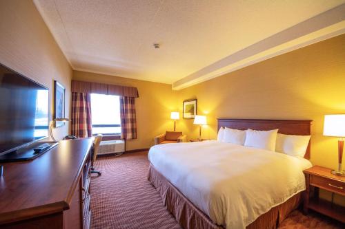 a hotel room with a bed and a desk at The Water Tower Inn - BW Premier Collection in Sault Ste. Marie