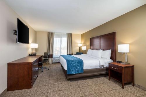 a hotel room with a bed and a desk and a television at Comfort Inn Tonopah in Tonopah