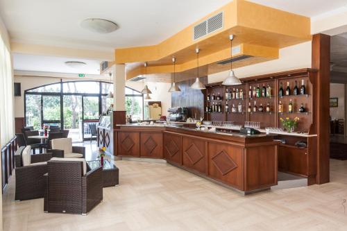 a restaurant with a bar and chairs in a room at Villa Hotel Del Sole in Chiusi