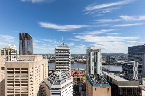 a city with tall buildings and a clock tower at Apartments @ 108 Albert in Brisbane