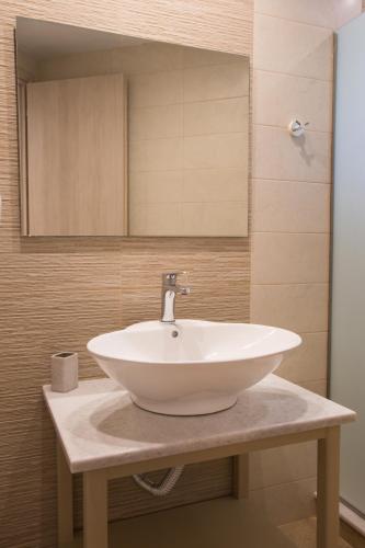 a white sink on a counter in a bathroom at Porfyris Studios and Apartments in Karpathos Town