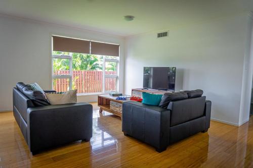 a living room with two chairs and a tv at Nobby Beach Holiday Village in Gold Coast