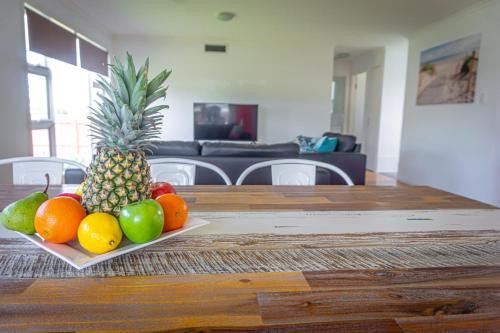 a plate of fruit on a wooden table at Nobby Beach Holiday Village in Gold Coast