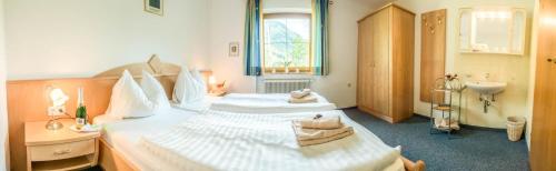 HintergöriachにあるFerienhaus Christine Bauerのベッド2台とシンク付きのホテルルームです。