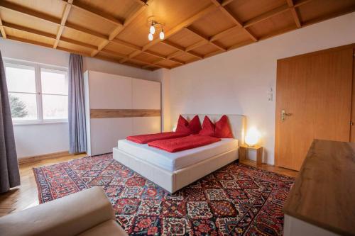 una camera da letto con un letto con cuscini rossi di Ansitz Hofer a Fulpmes