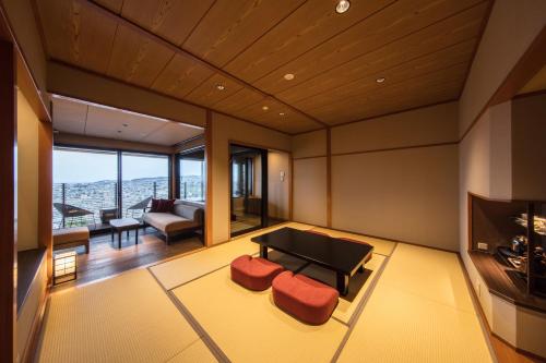 a living room with a couch and a television at Shoho in Matsumoto