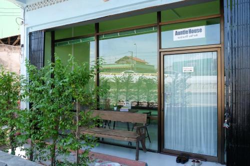 a bench in front of a window of a building at Auntie House985 in Phra Nakhon Si Ayutthaya