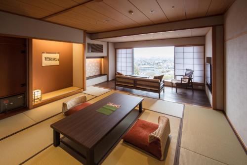 a living room with a table and chairs at Shoho in Matsumoto