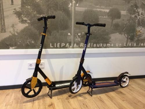 two scooters parked in front of a window at Simple & Elegant Apartment in Liepāja