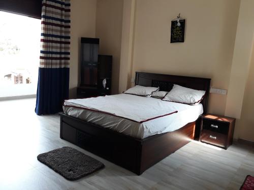 a bedroom with a bed and a large window at Rohan's Residence in Kandana