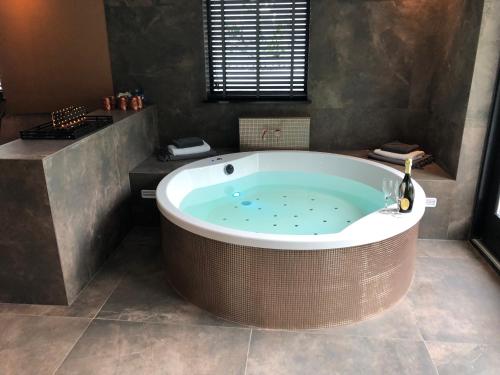 a large bathroom with a large tub in a room at Luxexcellent super suite in Nuland