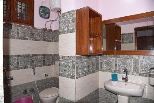 a bathroom with a toilet and a sink at anjani mansion in Hyderabad