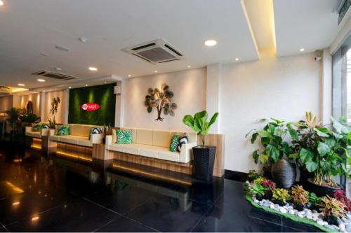 a lobby with a couch and potted plants at My Hotel @ KL Sentral in Kuala Lumpur
