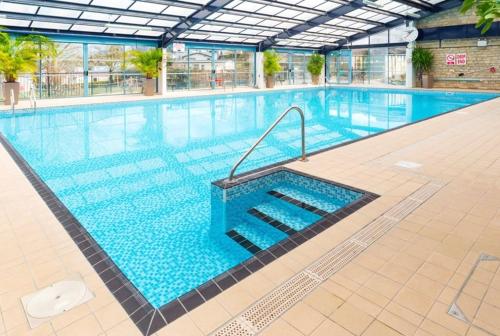 a large swimming pool in a building at Swanage Bay View caravan in Swanage