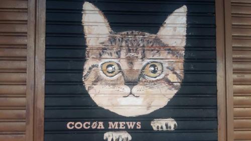 a painting of a cat on the side of a garage at Cocoa Mews Cafe and Homestay in George Town