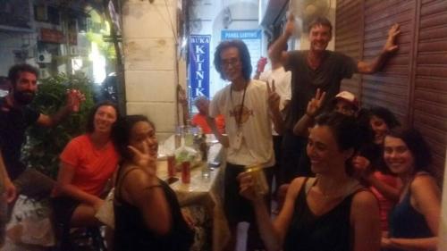 a group of people posing for a picture at a party at Cocoa Mews Cafe and Homestay in George Town