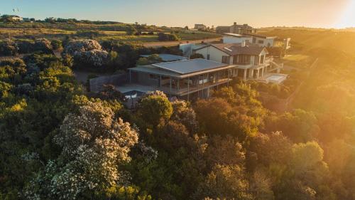 an aerial view of a house in the forest at Oubaai Villa by Raw Africa Collection in Herolds Bay