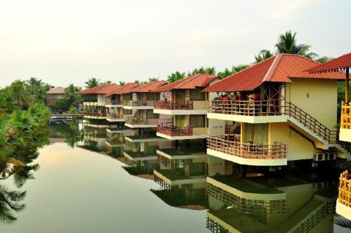 a row of apartment buildings on the water at Kalathil Lake Resort in Vaikom
