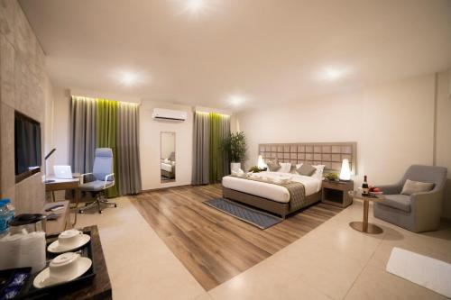 a large bedroom with a bed and a desk and chair at juSTa Rangers Munnar in Munnar