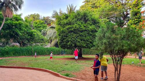 a group of people standing in a park at Hotel Godwin - Colaba in Mumbai