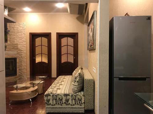a living room with a couch and a tub and a refrigerator at DAUGAVPILS in Daugavpils