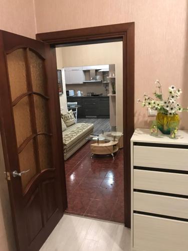 a living room with a door and a living room with a couch at DAUGAVPILS in Daugavpils
