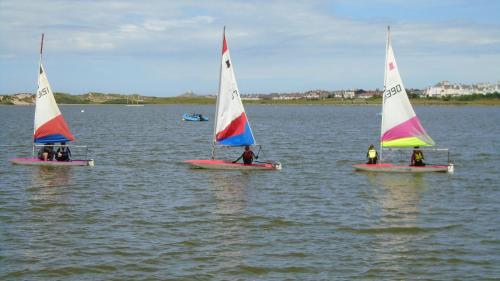 a group of people on small sailboats in the water at TEA in Liverpool - Private - Quiet - Ground Floor - En-suite - Walk-in-shower in Liverpool