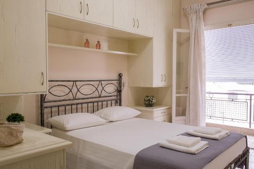 a bedroom with a large bed with towels on it at Beautiful Corfu City Apartment in Corfu Town