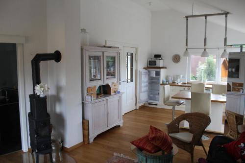 a kitchen with a table and a stove in it at Haus Boddensonne in Fuhlendorf