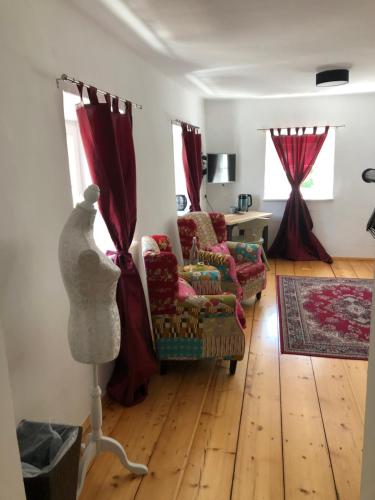 a living room with a chair and a table at Fenix Hall Boutique Hotel Hallstatt in Hallstatt
