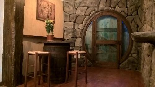 a painting of a bar with a stone wall at B&B Pervinca in Rocca Grimalda