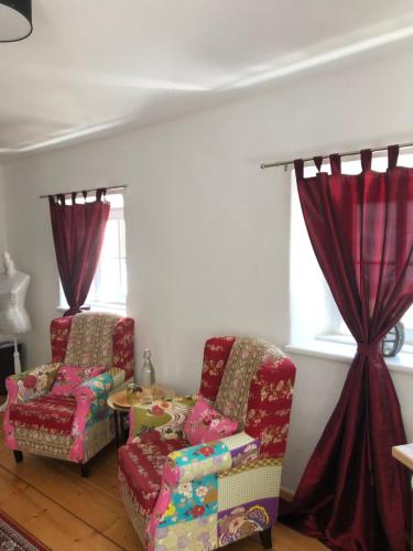 a living room with two chairs and a table at Fenix Hall Boutique Hotel Hallstatt in Hallstatt