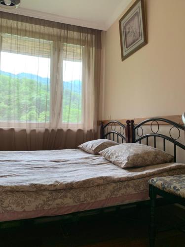 a bedroom with two beds in front of a window at Anush restaurant/hotel in Vanadzor