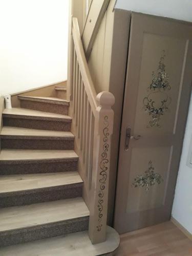 a door leading up to a stairway with a staircase at Reginas Ferienhäuschen in Krieglach