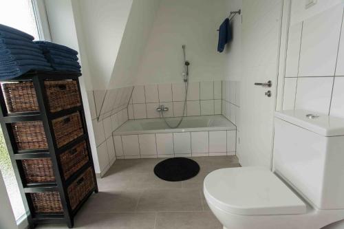 a bathroom with a toilet and a bath tub at Das gelbe Haus 3 in Winterberg