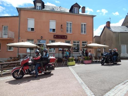 a group of people riding motorcycles in front of a building at Le Lion D'or in Ouroux en Morvan