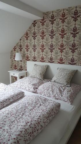 a bedroom with a bed with red and white comforter at Ferienhaus BARFLY in Traben-Trarbach