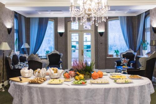 a table with plates of food on top of it at Hotel Fryderyk in Duszniki Zdrój