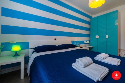 Łóżko lub łóżka w pokoju w obiekcie Casa di Colombo