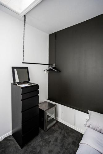 a bedroom with a bed and a black wall at Eight Rooms in Stockholm