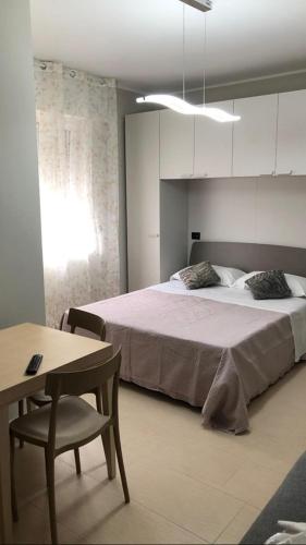 a bedroom with a bed and a table and a chair at Bed&Breakfast Luna in San Salvo