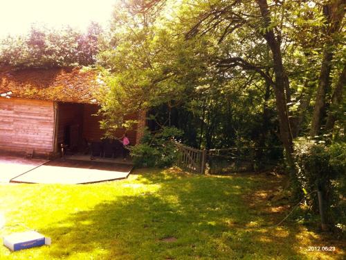 a backyard with a yard with a house and trees at Cosy Authentic Farmhouse - LaComte5 in Vielsalm
