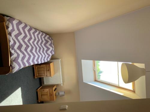 a bedroom with a bed with a window and a pillow at MS-OTEL POKOJE GOSCINNE 1,2,3 OSOBOWE ŻYWIEC Jezioro Żywieckie in Pietrzykowice