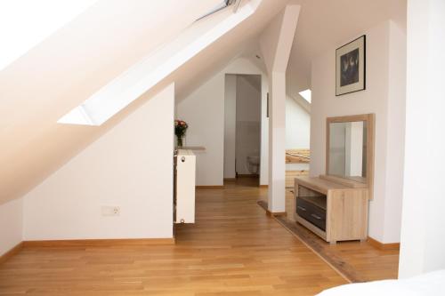 an attic room with a staircase and a mirror at Hotel Stern in Düsseldorf