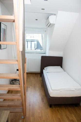 a small room with a bed and a staircase at Hotel Stern in Düsseldorf