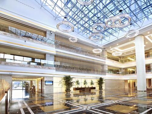 a large lobby with a large chandelier in a building at Pullman Xiamen Powerlong in Xiamen