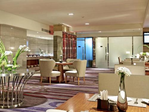 a living room with a table and chairs at Pullman Xiamen Powerlong in Xiamen