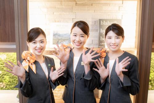 a group of three women holding up their hands at Super Hotel Anan Tomioka in Anan