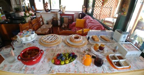 a table topped with plates of food and fruit at La Piana degli Ulivi in Rossano
